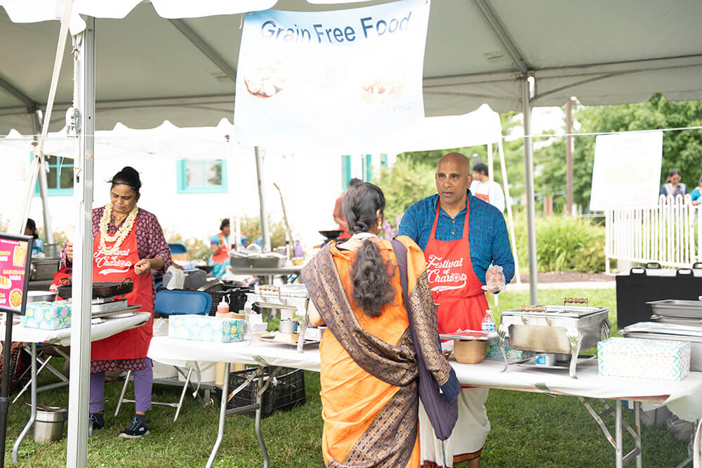 Live cooking demonstration at a festival food tent